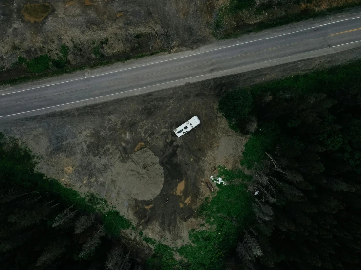 a small white van on a open road