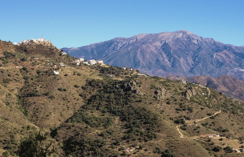 the mountains range below with houses built into them