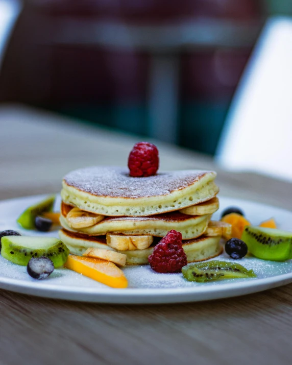 a stack of pancakes on top of a white plate