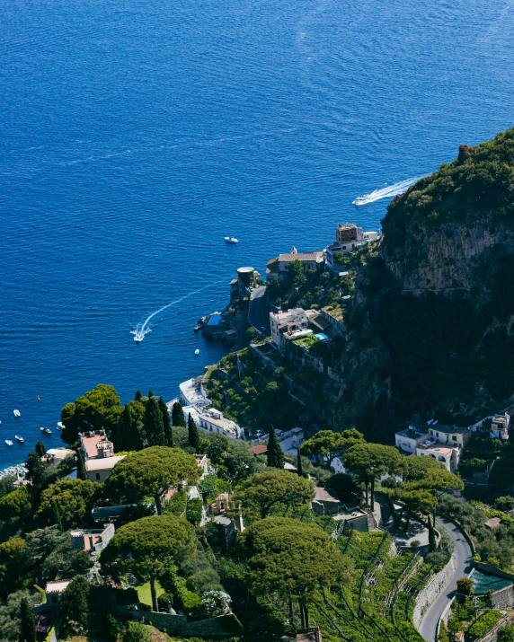 a hillside overlooking the water with houses on it