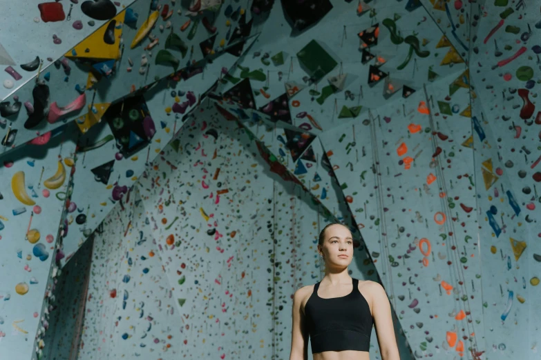 a woman wearing a black  top and yoga pants in a gym