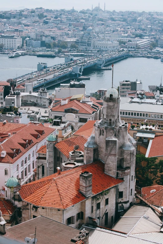 an aerial view of several red roofed buildings next to water