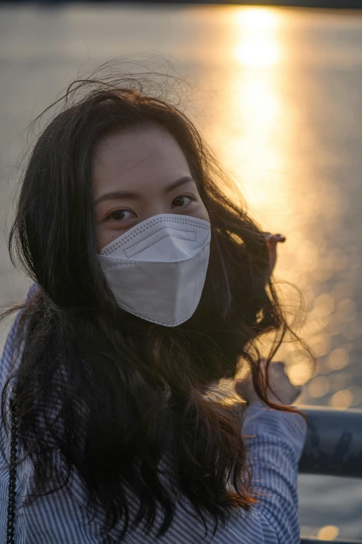 young woman in blue shirt with protective face mask on