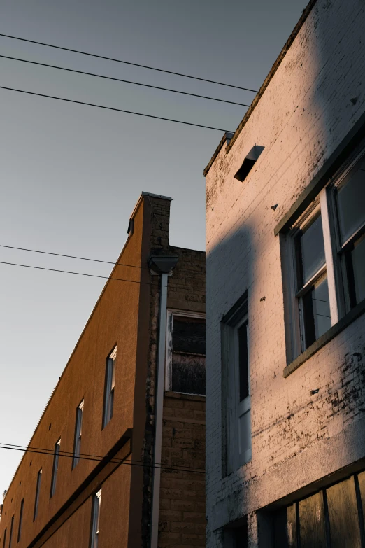 two brown and white buildings on the other side of an intersection