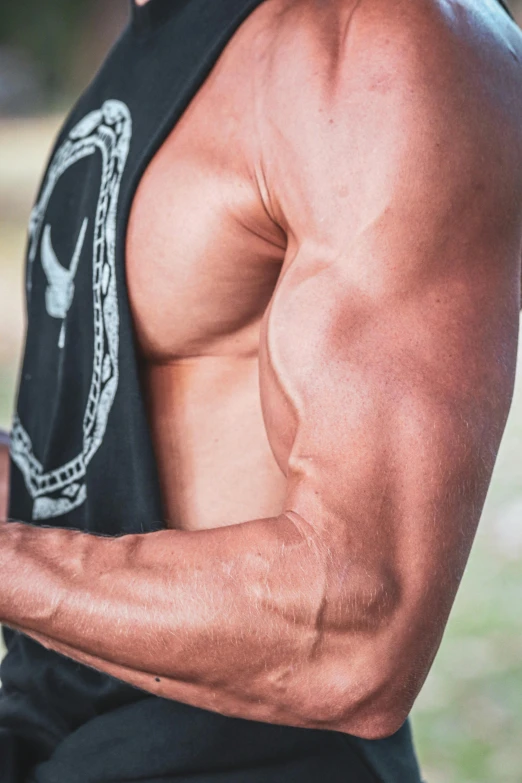 a man wearing an old timey tank top looking down