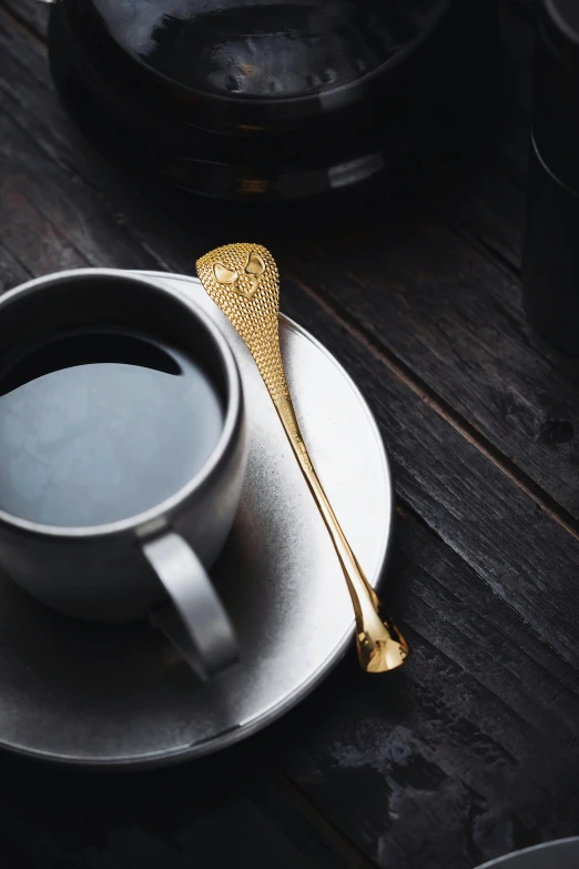 a fork rests on a coffee cup on the table