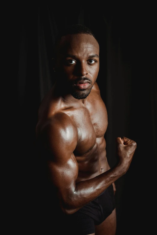 a man in black underwear is flexing his muscles