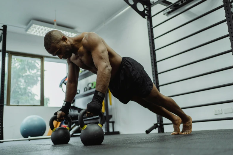 a man performs exercises with kettlebells at the gym