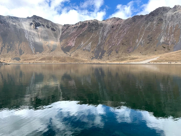 a beautiful s of the mountains reflected in the water