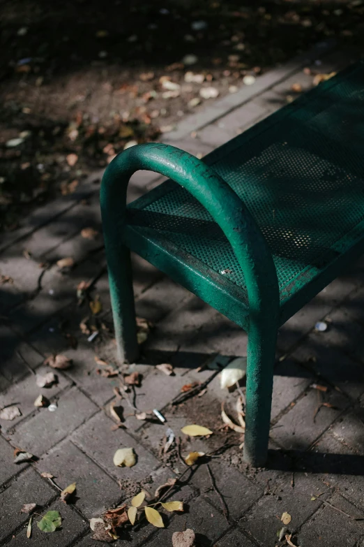 a park bench is placed on the side walk