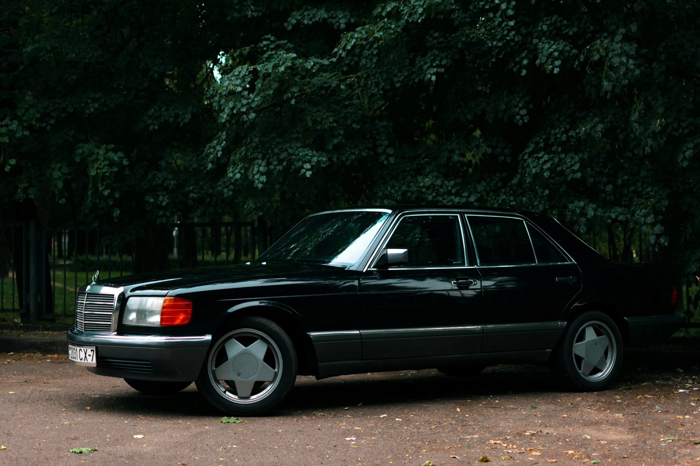 a black car parked on the side of the road