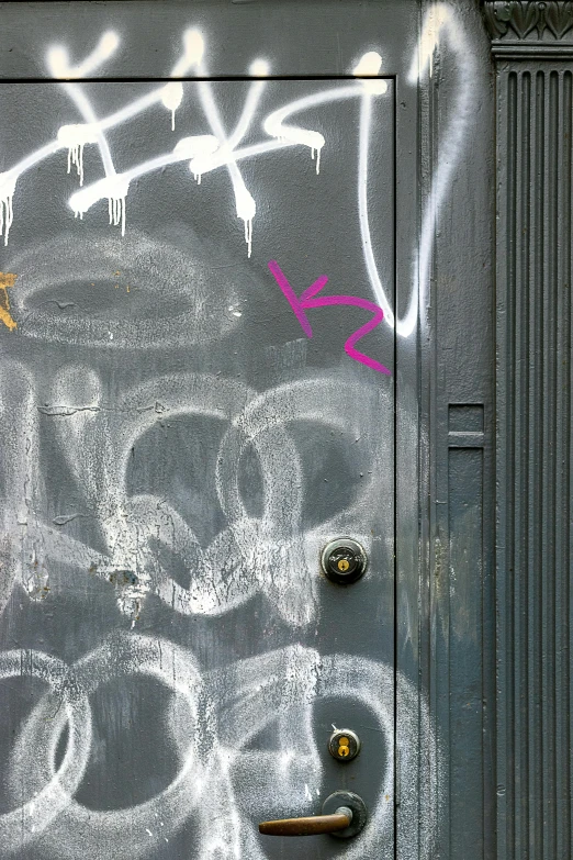 an old grungy door in the process of being tagged