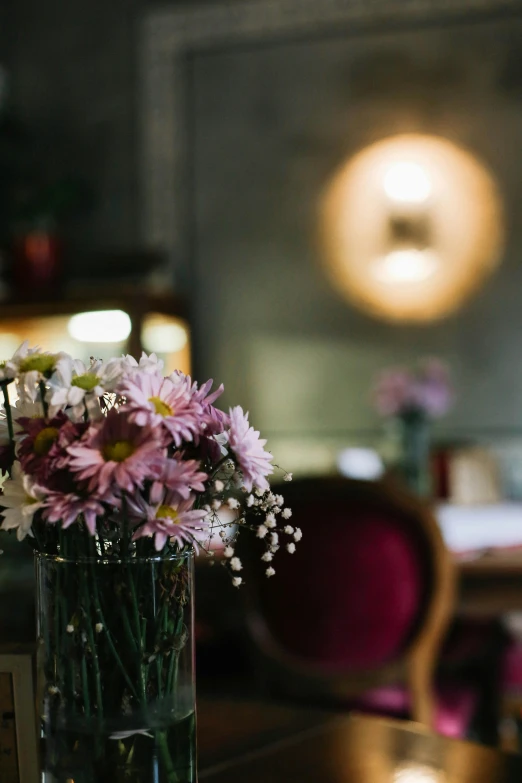 a vase filled with flowers sitting on top of a wooden table