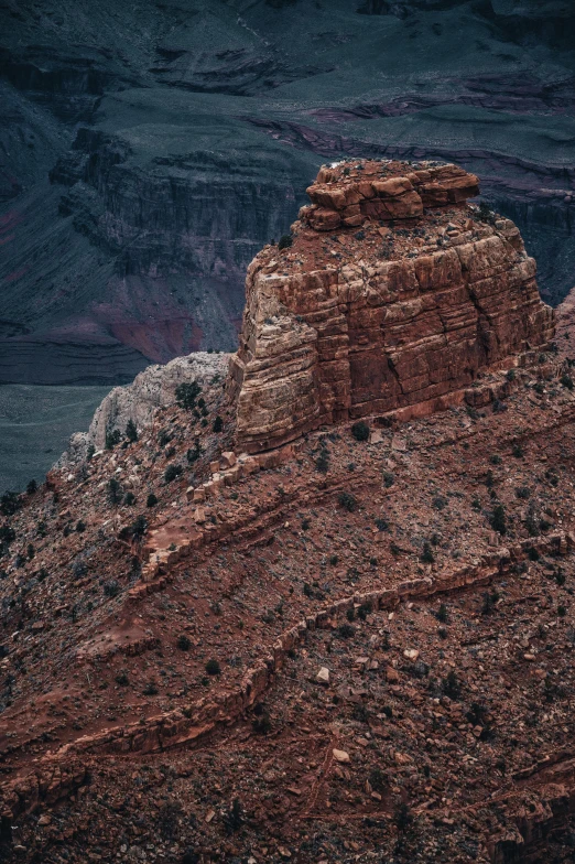 red rock cliff with sp vegetation growing along the edge