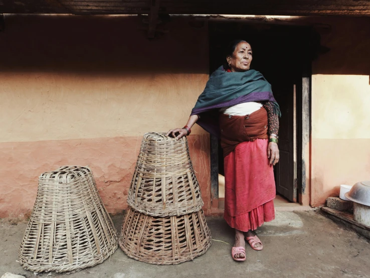 a woman is standing by some baskets