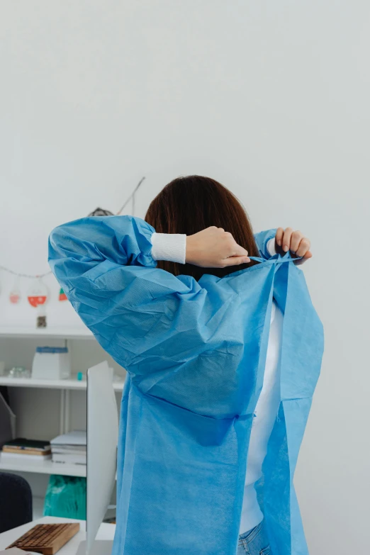 a woman is covering herself with blue material