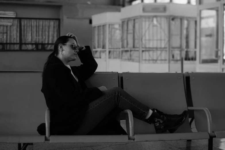 a man sitting on a bench looking in his cellphone