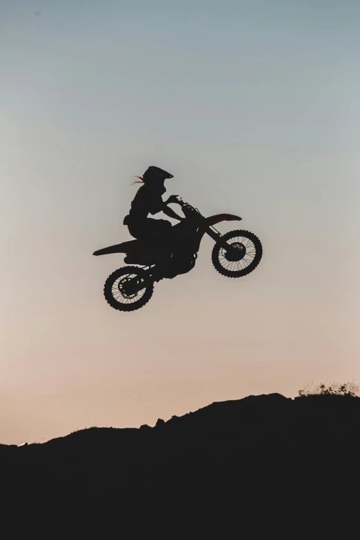 a person on a motorcycle jumping up in the air