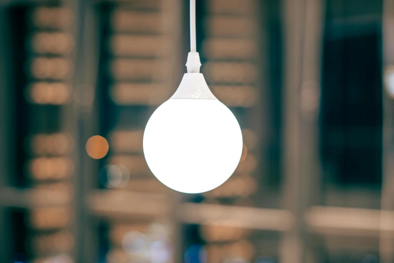 the light bulb hangs over the counter, with several dishes behind it