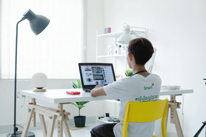 a person sitting at a desk working on a computer