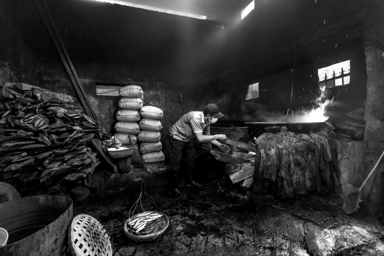 the man is making a pizza in his restaurant