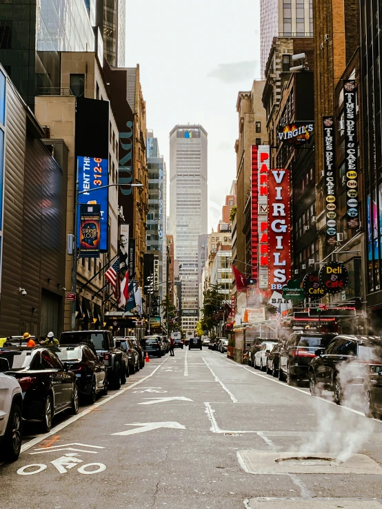 an empty city street with car's and pedestrians