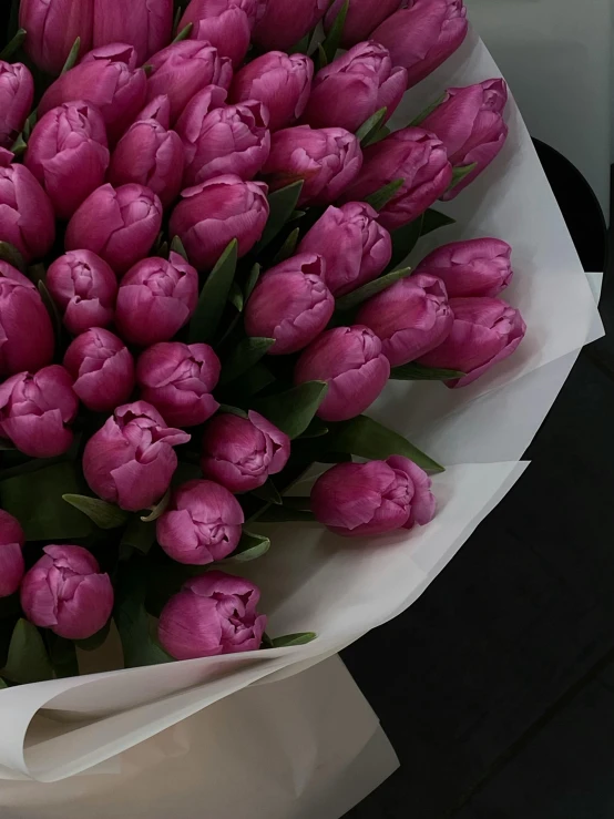 a bouquet of pink tulips laying on a table