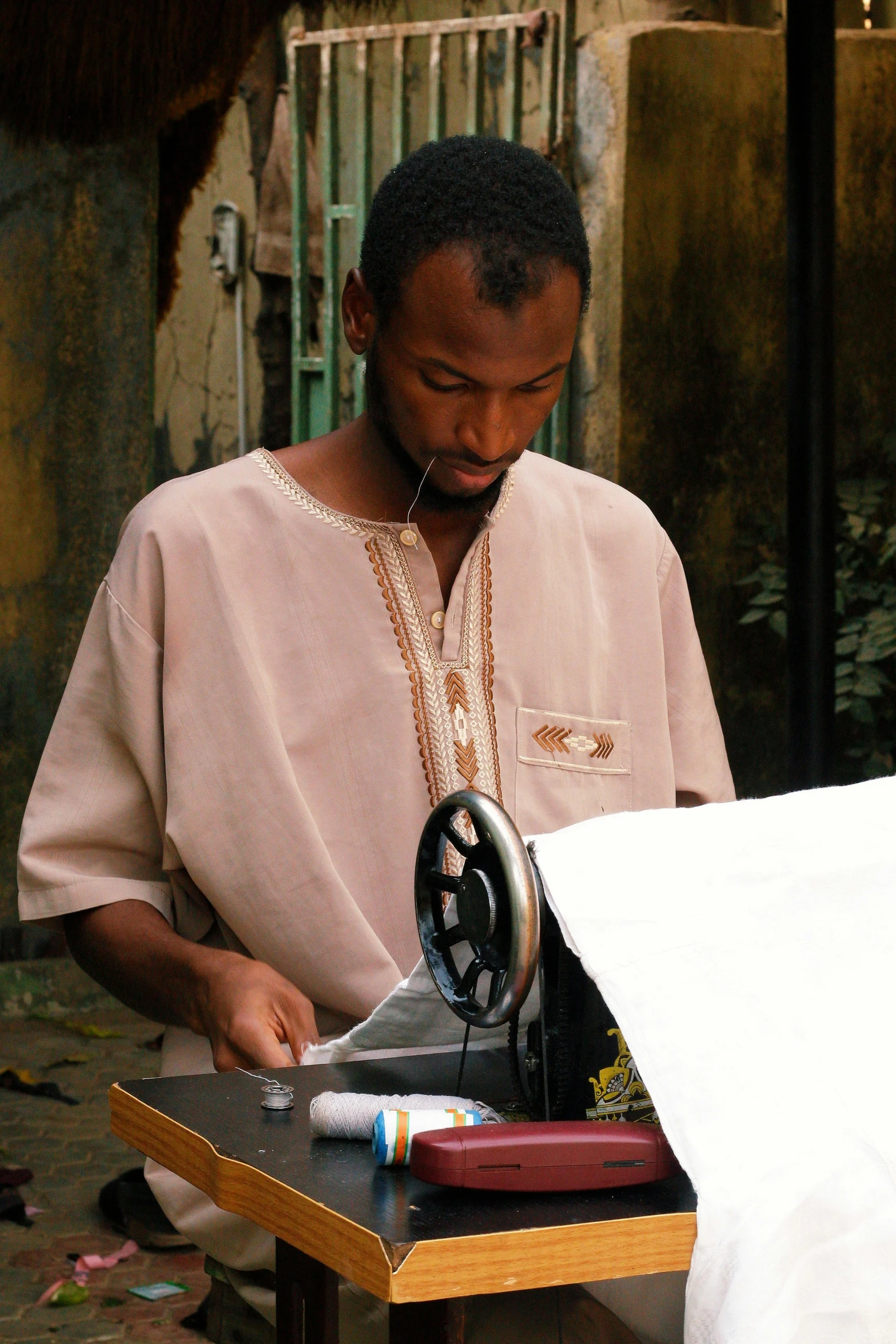a man using a sewing machine to sew soing