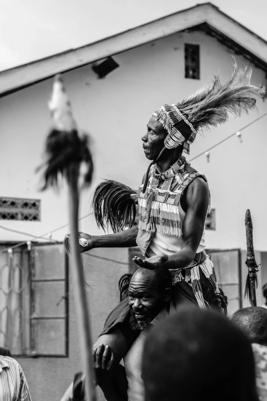 a man dressed in elaborate headdress on his horse