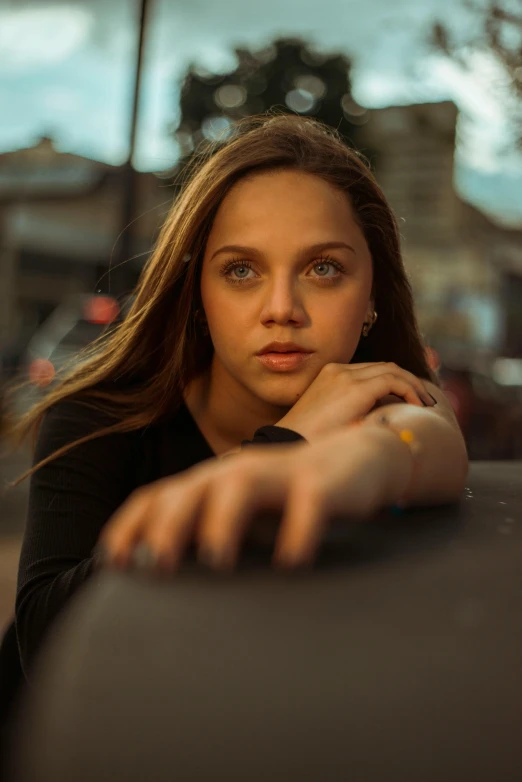 the woman sits in front of the camera