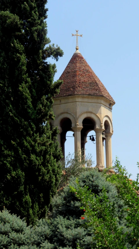 the bell tower is in the top of the hill