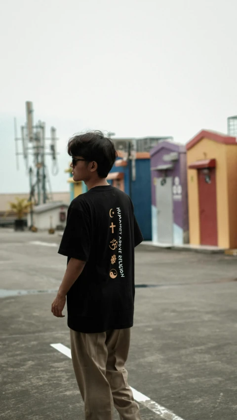 boy in black shirt and tan pants riding a skateboard