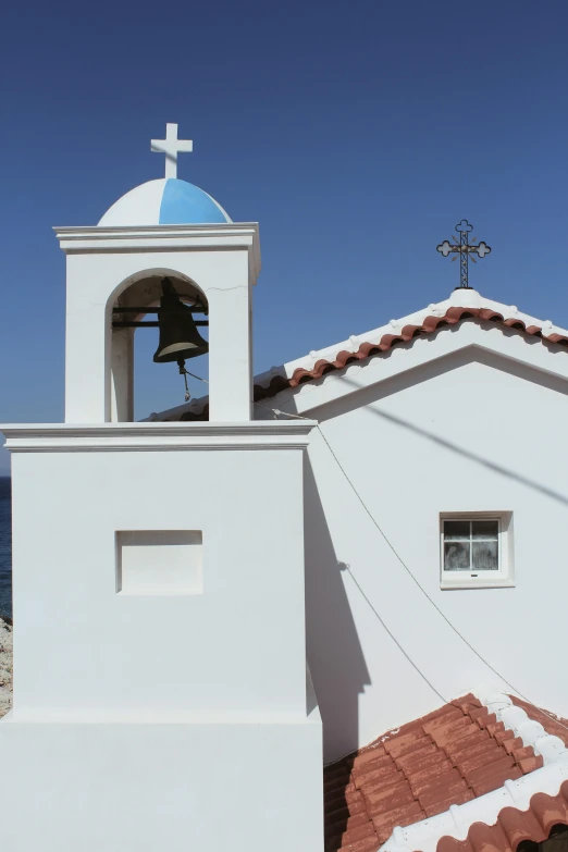 the bell tower has been adorned with a blue and white cross