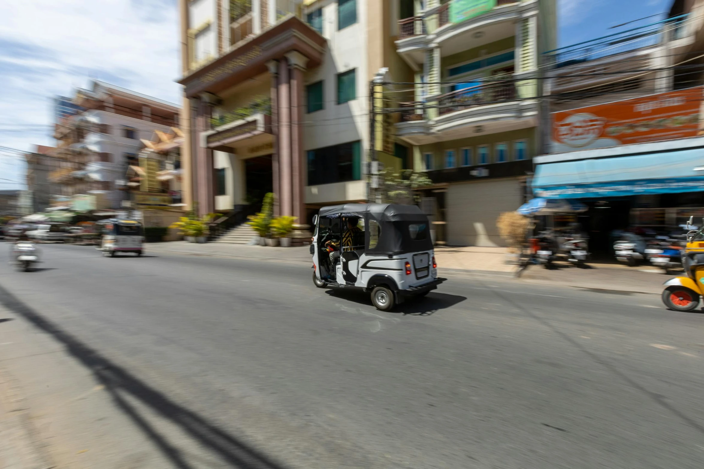 a golf cart riding down the street