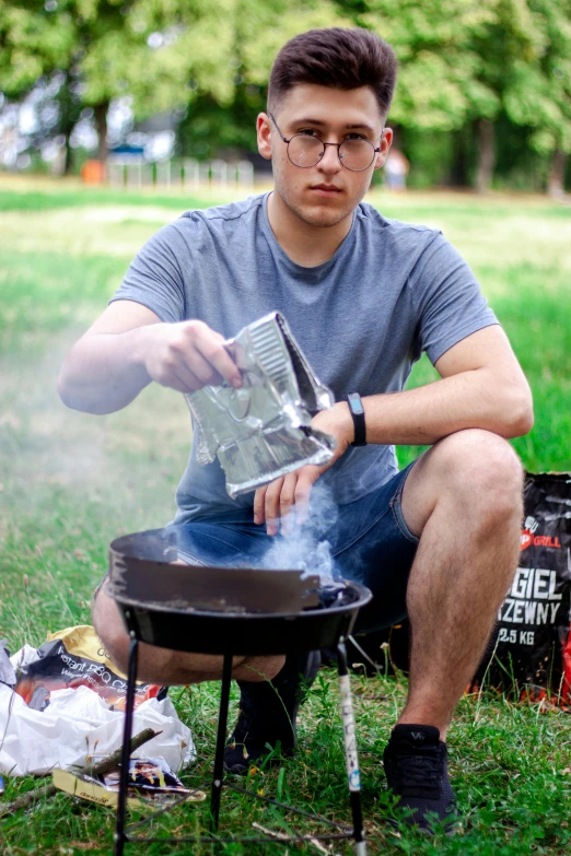 the man is cooking on a small stove