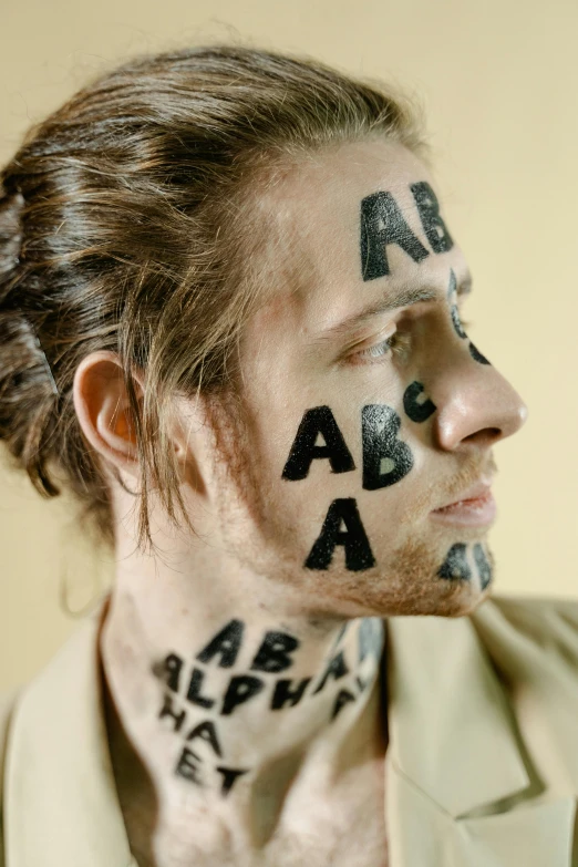 the man with some letters painted on his face