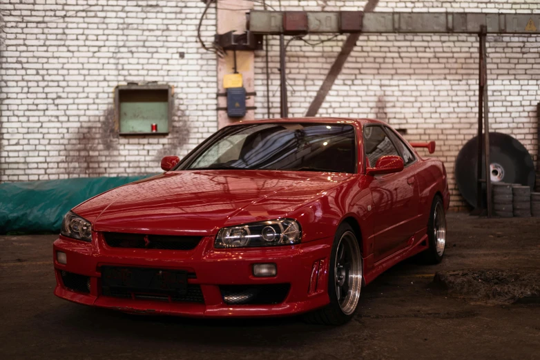 a red car is parked in the garage