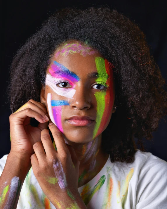 a woman with a face painted bright colors