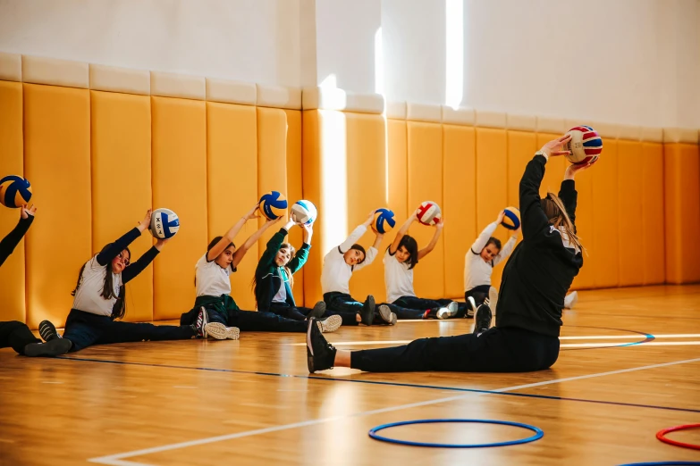 a group of children with ball caps in a gym