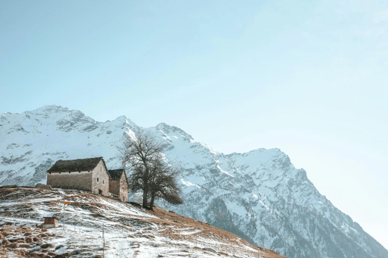 a house in the mountains with snow on top