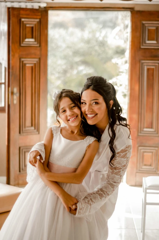 two girls dressed in white posing for the camera