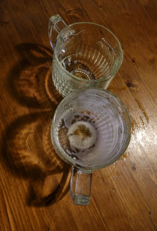 two glasses are shown with an old strainer