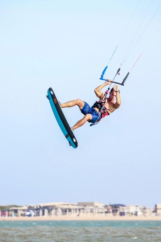 the man is riding his board on the water