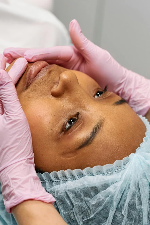 a person getting their forehead examined in the middle