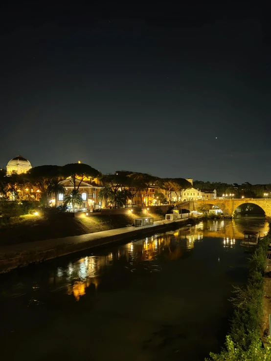 a bridge and its reflection in a body of water at night