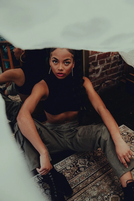 woman sitting on an oriental oriental rug posing for the camera