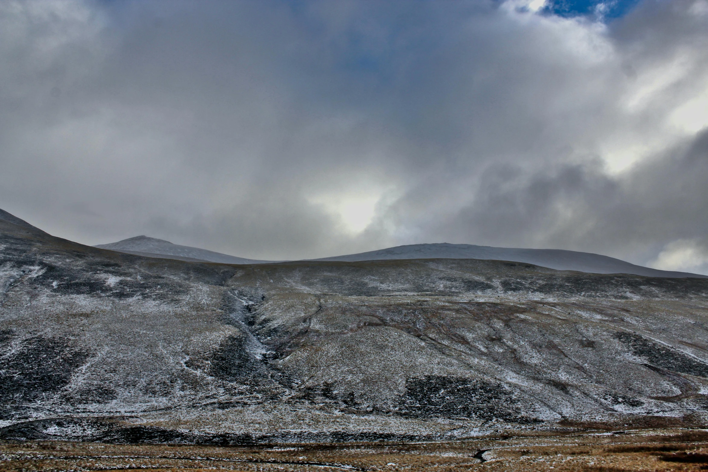 a group of mountains in the distance with snow on them