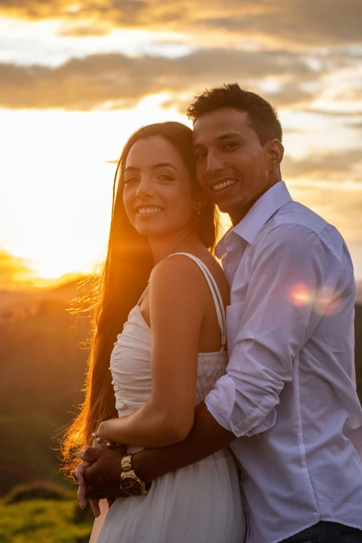 man and woman emcing in front of a sunrise