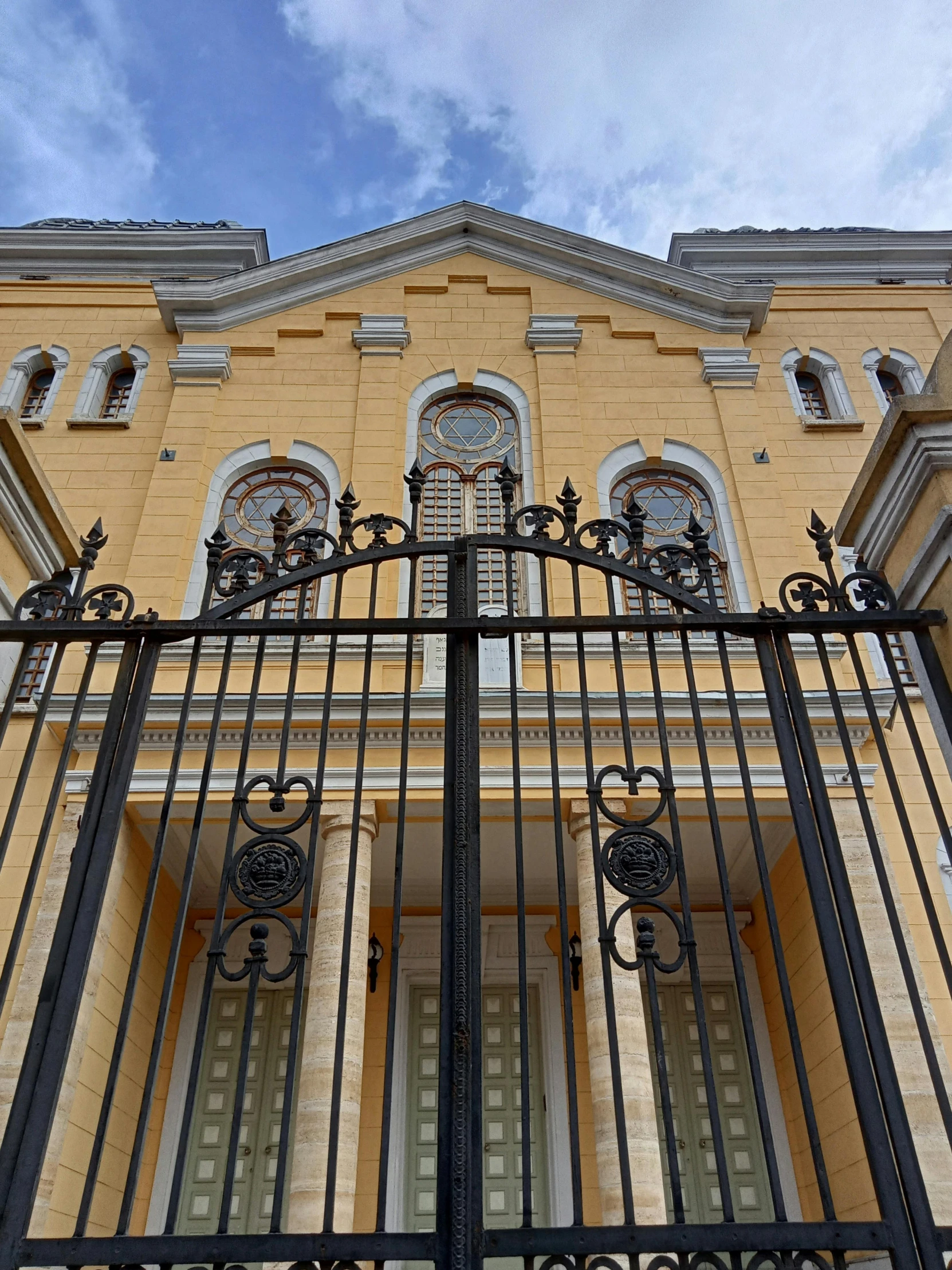 the top part of a fence has elaborate designs on it