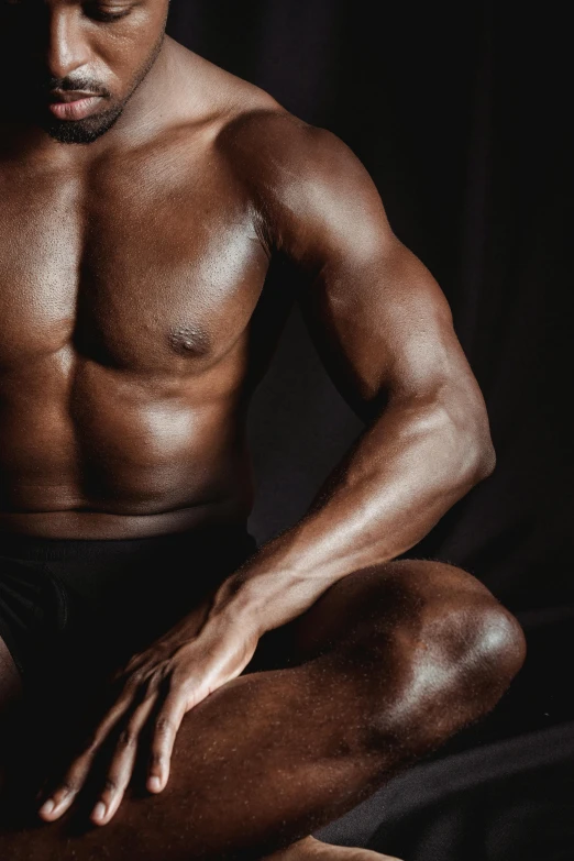 a black man with  sitting in the dark